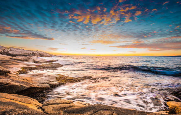 Peggy's cove lighthouse sunset ocean view landscape in Halifax, Nova Scotia stock photo