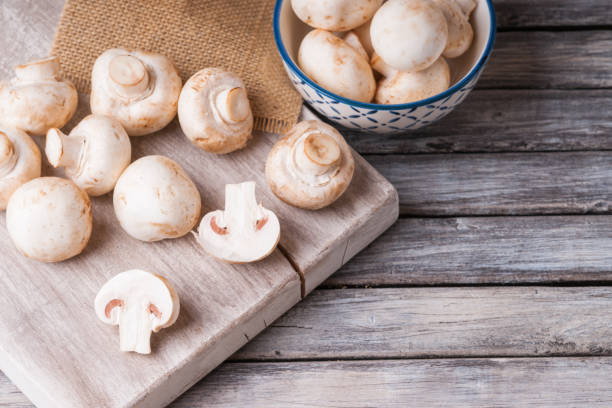 istock Fresh champignons on a cutting board and in a bowl 953010304