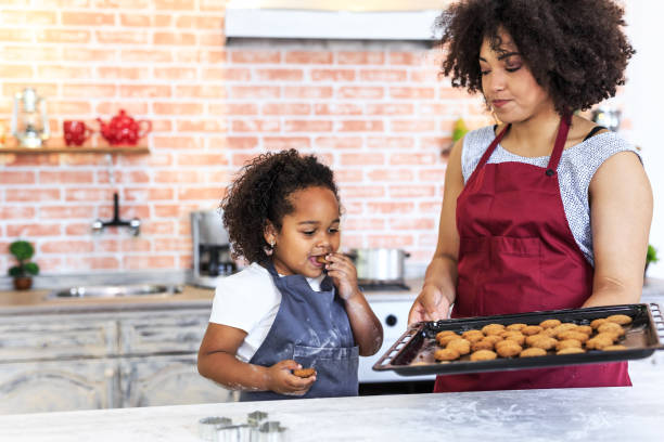 istock Cute little girl baking at home with mom 953010416