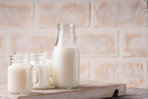 istock Jars and bottle with milk on a cutting board 953010448