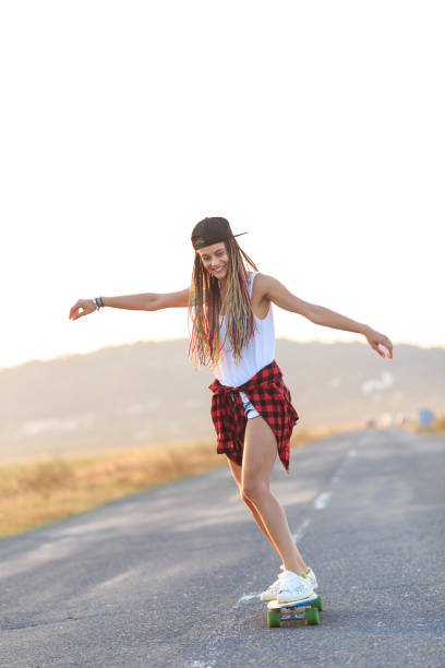 istock Smiling skater moving down on country road 953010550