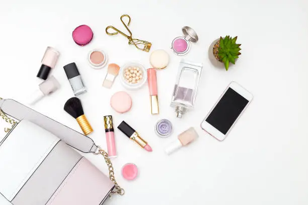 Photo of Woman's swimsuit and cosmetics set on a white background. Flat lay