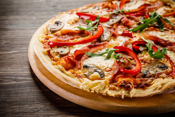 istock Pizza margherita with arugula on wooden background 953017736