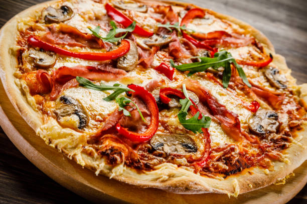 istock Pizza margherita with arugula on wooden background 953017744