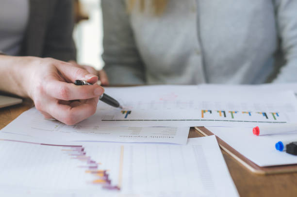 istock two attractive business woman teamwork working on table with strategy and analyze from document for decision in planning new project. 953019682
