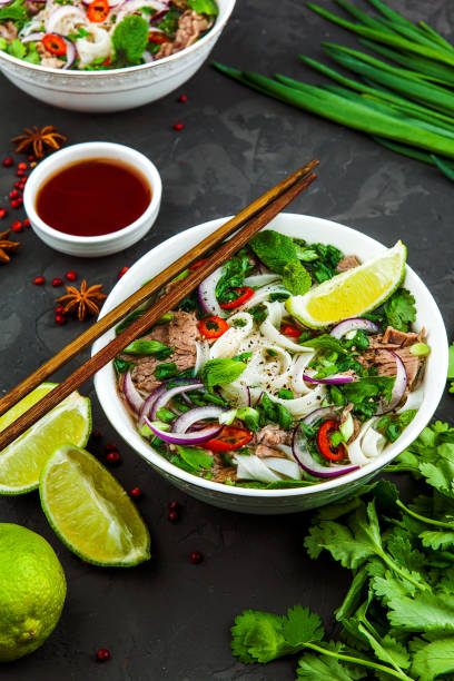 istock Vietnamese Beef Noodle Soup Pho Bo with beef on dark background 953026772