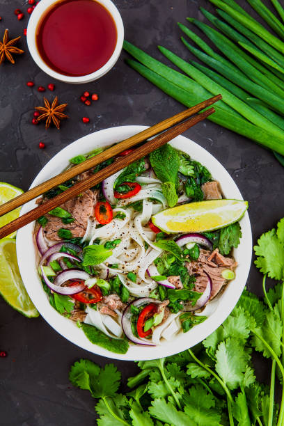 istock Vietnamese Beef Noodle Soup Pho Bo with beef on dark background 953026802