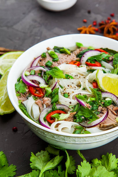 istock Vietnamese Beef Noodle Soup Pho Bo with beef on dark background 953026822