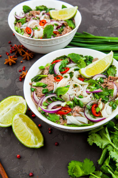 istock Vietnamese Beef Noodle Soup Pho Bo with beef on dark background 953026930
