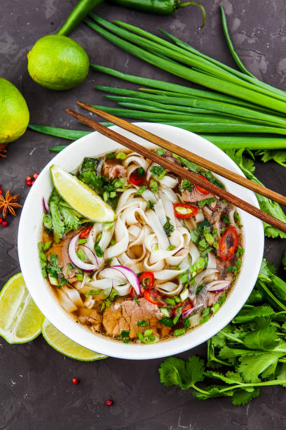 istock Vietnamese Beef Noodle Soup Pho Bo with beef on dark background 953026950