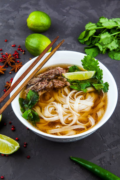 istock Vietnamese Beef Noodle Soup Pho Bo with beef on dark background 953026970