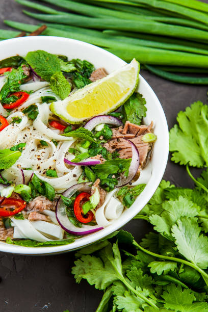 istock Vietnamese Beef Noodle Soup Pho Bo with beef on dark background 953026988