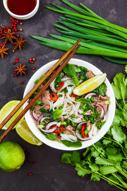 Vietnamese Beef Noodle Soup Pho Bo with beef on dark background