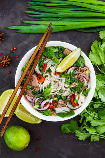 istock Vietnamese Beef Noodle Soup Pho Bo with beef on dark background 953027124