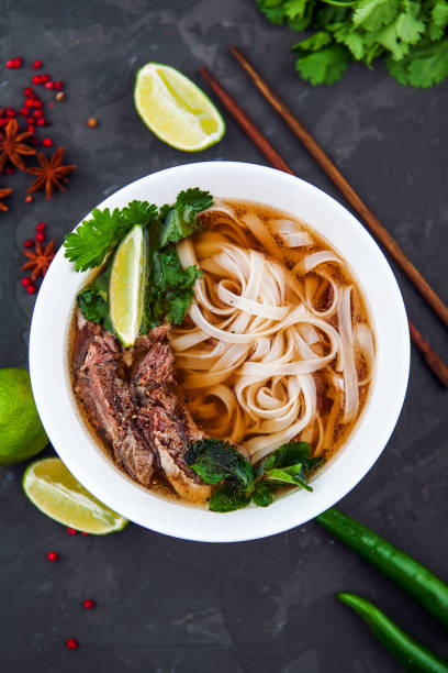 istock Vietnamese Beef Noodle Soup Pho Bo with beef on dark background 953027182