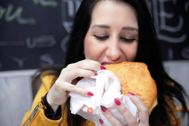 istock Girl eating a hamburger 953027328