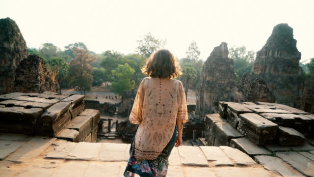 Woman walking    in Angkor Temple in Cambodia