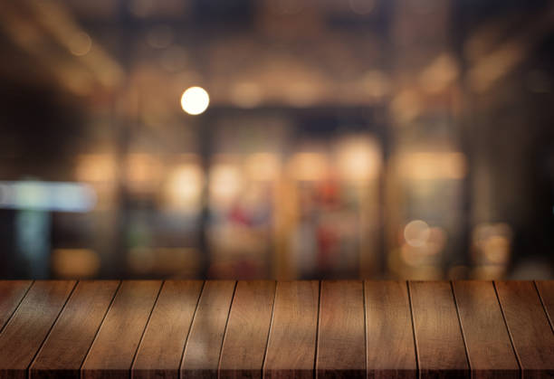 istock Wooden board empty table  cafe, coffee shop, bar blurred background can be used for display or montage your products and Mock up 953028150