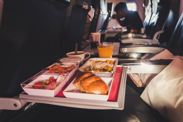 lunch in airplane. inflight economy class meal on tray - cooked bread food cup imagens e fotografias de stock