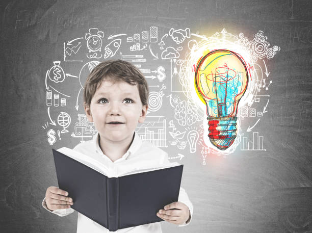 istock Cute little boy with a book, idea 953032506
