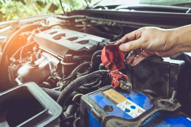 istock Hand of technician checking battery terminals and engine on the car. 953036488