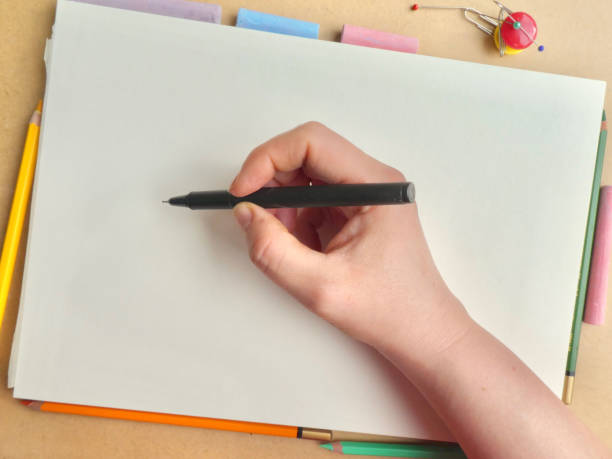 istock Hand drawing on white paper with coloring tools around it 953036904