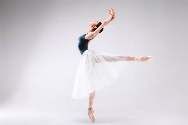 istock Slim beautiful ballerina is posing on a white background 953040846