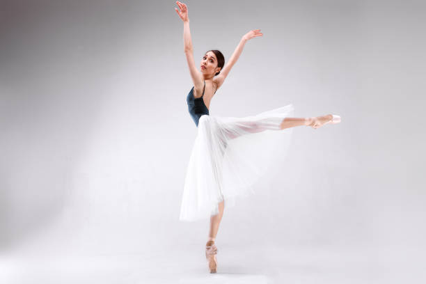 istock Slim beautiful ballerina is posing on a white background 953040848