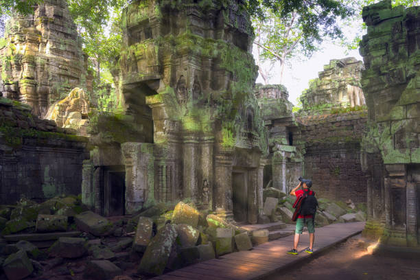 Traveler take a photo, Ta prohm temple or Tom rider temple  is on Angkor wat temple area in Siem reap, Combodia, Asia, unesco, amazing, travel and temple concept