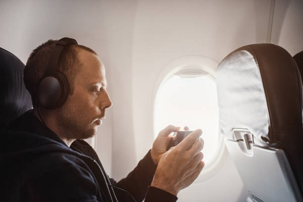 istock Traveling man on airplane flying 953052352