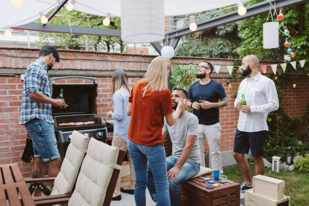 istock Friends Watching Soccer Game On Big Screen In Backyard 953052508