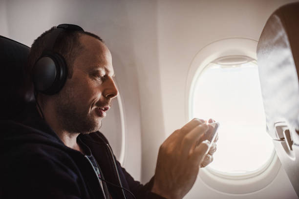 istock Traveling man on airplane flying 953052928