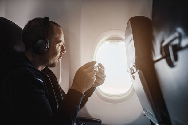 Traveling man on airplane flying