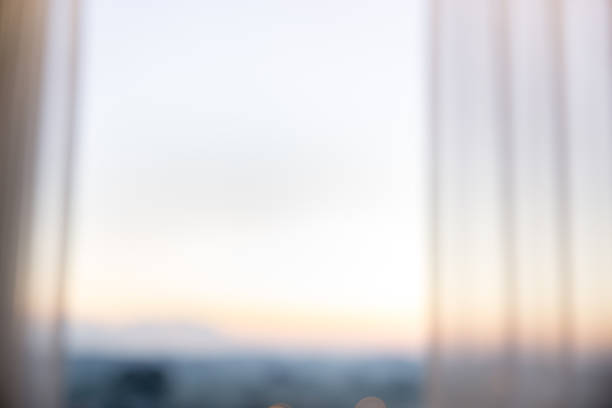 istock Defocused curtain window with sunlight in the early morning. 953055898