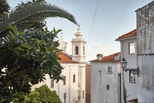 Photo of Old Lisbon Portugal steet. Arch and stair. Buildings facade. Church of St. Vicent