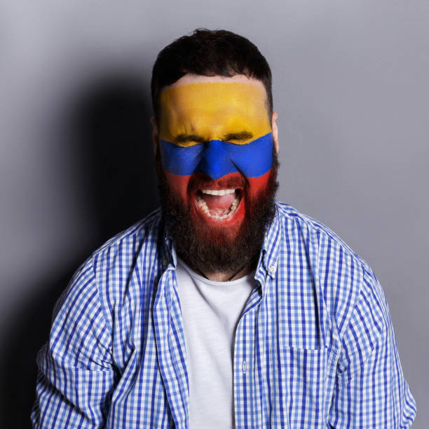 istock Young man with Columbia flag painted on his face 953058284