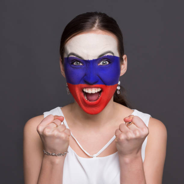 istock Young woman with Russian flag painted on her face 953058410
