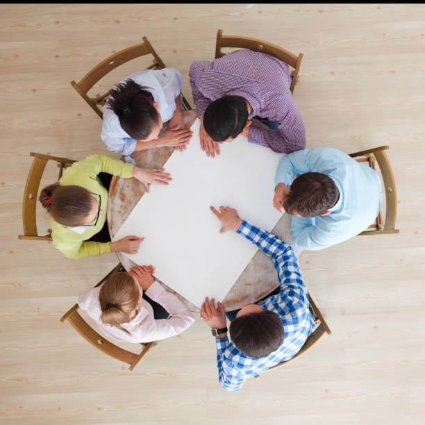 istock People team pointing to white paper 953058690