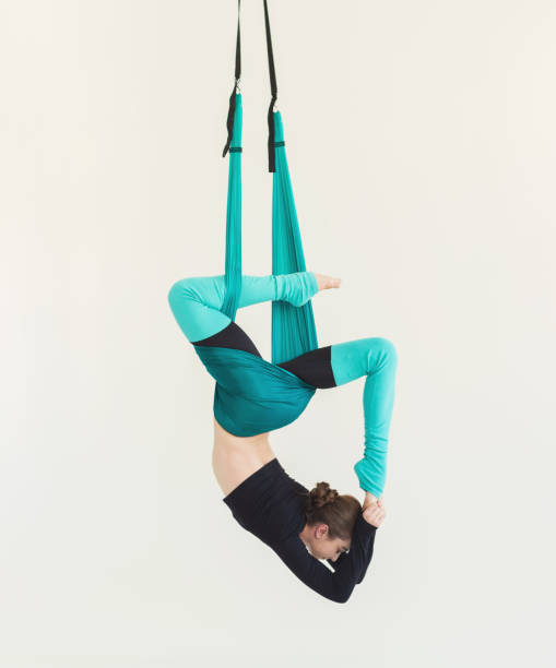 istock Woman practicing fly yoga over white background 953058850