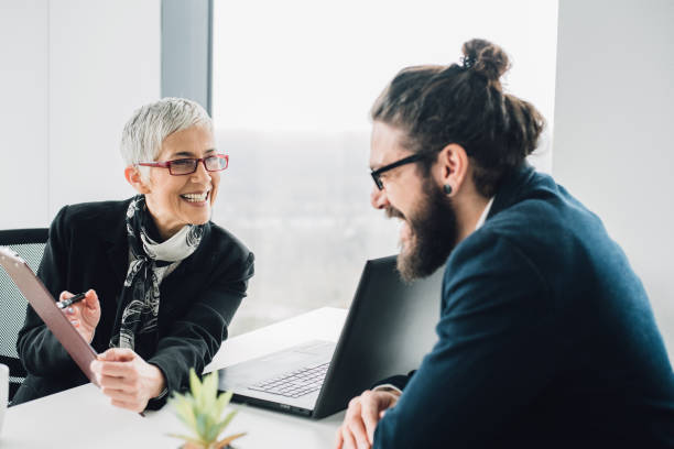 istock Coworkers looking at documents and smiling at office 953064814