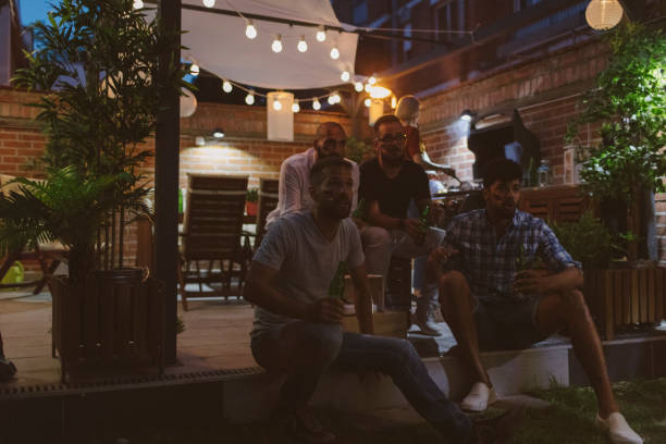 istock Friends Watching Soccer Game On Big Screen In Backyard 953065448