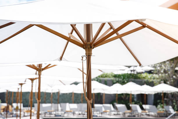 Sunlight through white parasol umbellar. Garden furniture function design decoration.
