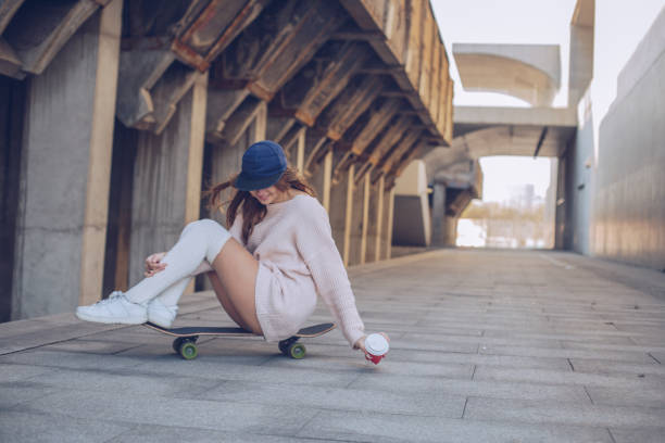 istock Woman sitting on skateboard 953067052
