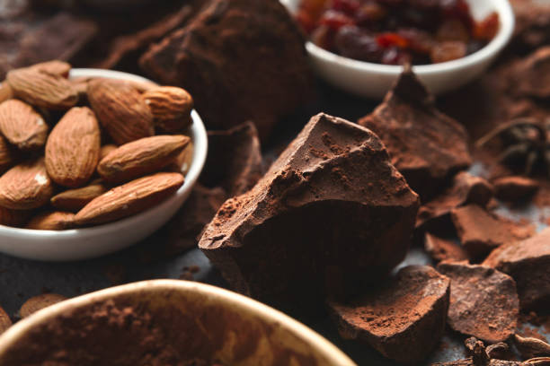 istock Crushed chocolate bar pieces and cocoa on gray background 953073960