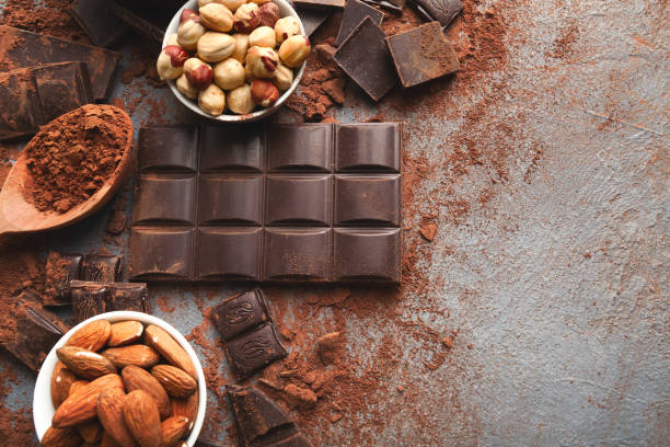 istock Crushed chocolate bar pieces and cocoa on gray background 953074076