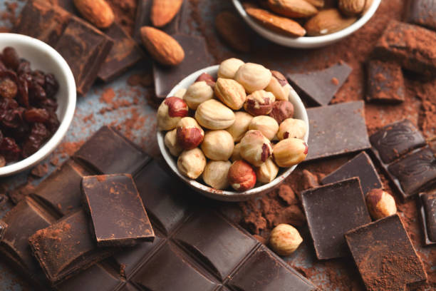 istock Crushed chocolate bar pieces and cocoa on gray background 953074322