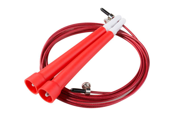 istock red gymnastic skipping rope, white background, metal cord in plastic braid, plastic handle 953074878