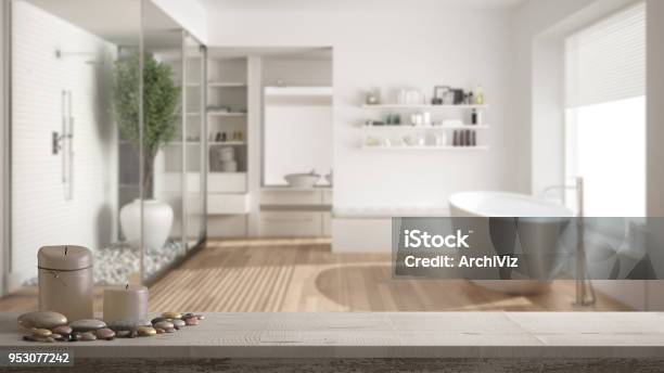 Wooden Vintage Table Top Or Shelf With Candles And Pebbles Zen Mood Over Blurred Minimalist Bathroom With Shower And Walkin Closet White Architecture Interior Design Stock Photo - Download Image Now
