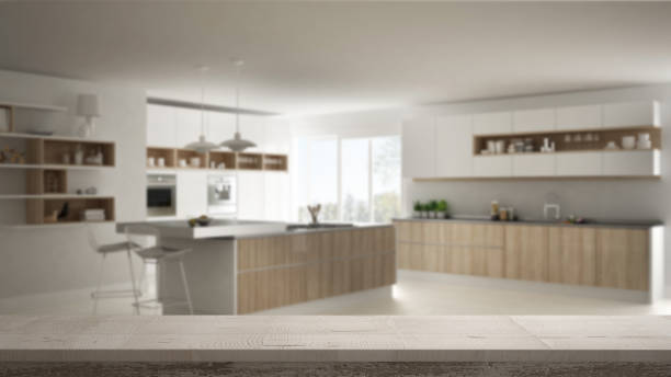 istock Wooden vintage table top or shelf closeup, zen mood, over blurred modern kitchen, white architecture interior design 953078596