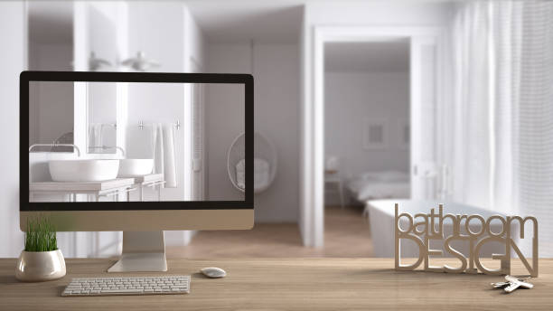 istock Architect designer project concept, wooden table with keys, 3D letters making the words bathroom design and desktop showing draft, blurred space in the background, interior design 953083822